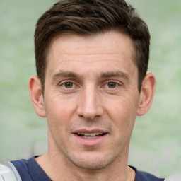 Joyful white adult male with short  brown hair and brown eyes