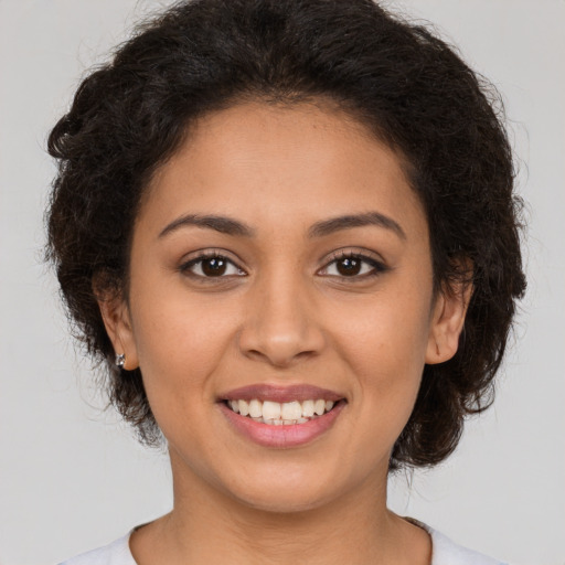 Joyful latino young-adult female with long  brown hair and brown eyes