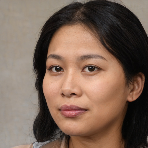 Joyful asian young-adult female with medium  black hair and brown eyes