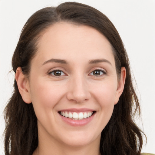 Joyful white young-adult female with long  brown hair and grey eyes