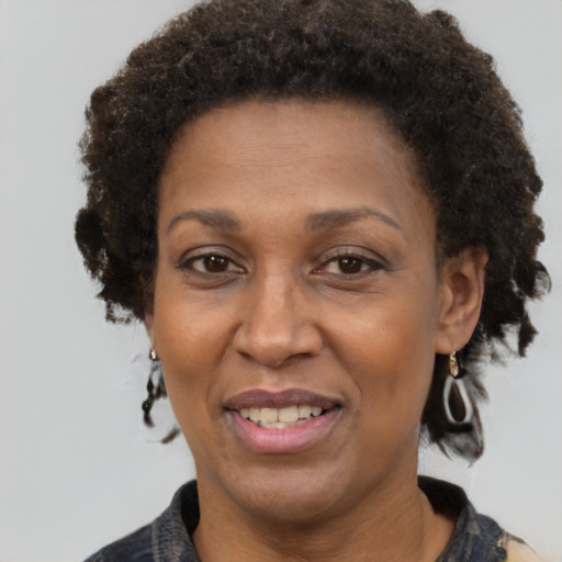 Joyful black adult female with short  brown hair and brown eyes