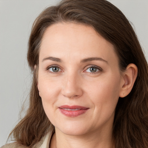 Joyful white young-adult female with long  brown hair and grey eyes