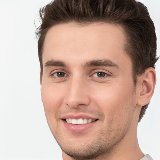 Joyful white young-adult male with short  brown hair and brown eyes