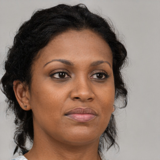 Joyful black young-adult female with medium  brown hair and brown eyes