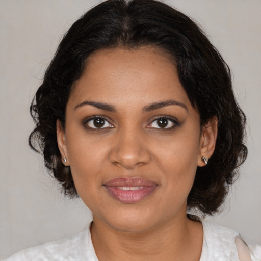 Joyful black young-adult female with medium  brown hair and brown eyes