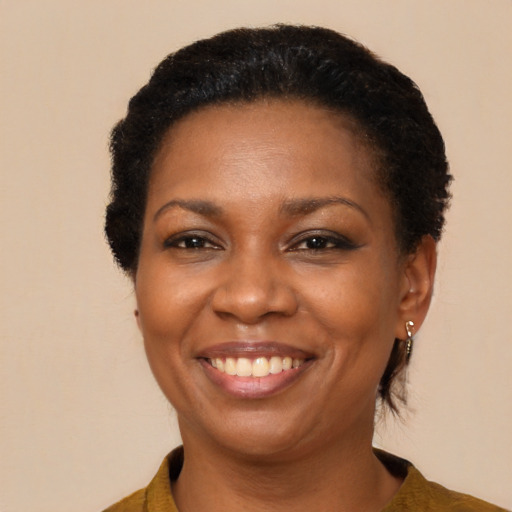 Joyful black adult female with medium  brown hair and brown eyes