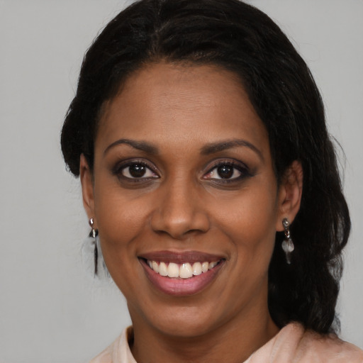 Joyful black young-adult female with medium  black hair and brown eyes