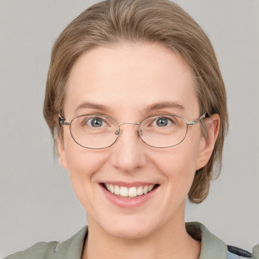 Joyful white adult female with medium  brown hair and blue eyes