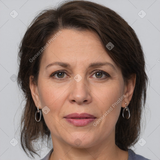 Joyful white adult female with medium  brown hair and grey eyes