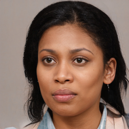 Joyful latino young-adult female with medium  black hair and brown eyes