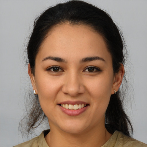 Joyful latino young-adult female with medium  brown hair and brown eyes