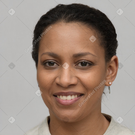 Joyful black adult female with short  brown hair and brown eyes