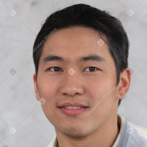 Joyful asian young-adult male with short  black hair and brown eyes