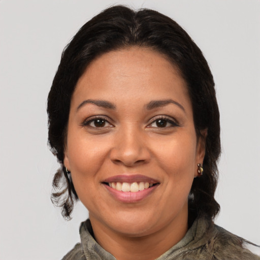 Joyful latino young-adult female with medium  brown hair and brown eyes