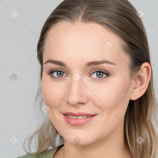 Joyful white young-adult female with long  brown hair and blue eyes