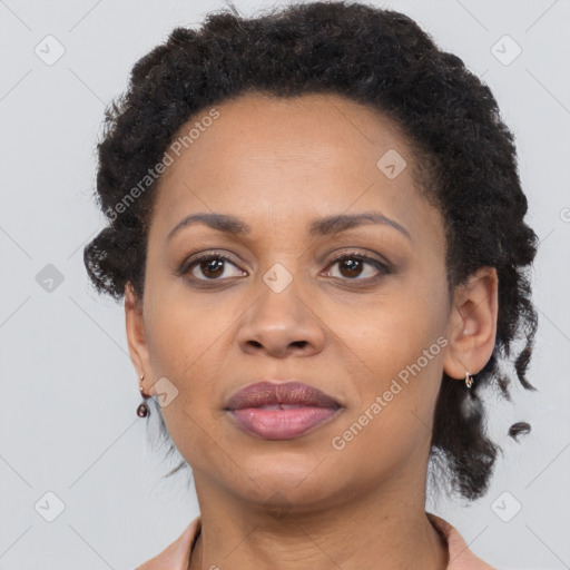 Joyful black adult female with short  brown hair and brown eyes