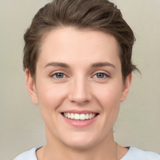 Joyful white young-adult female with medium  brown hair and green eyes