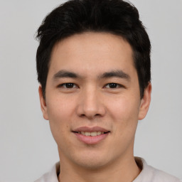 Joyful asian young-adult male with short  black hair and brown eyes