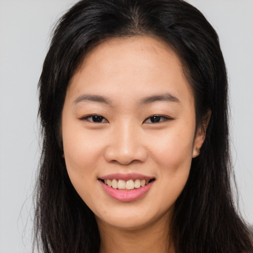 Joyful asian young-adult female with long  brown hair and brown eyes