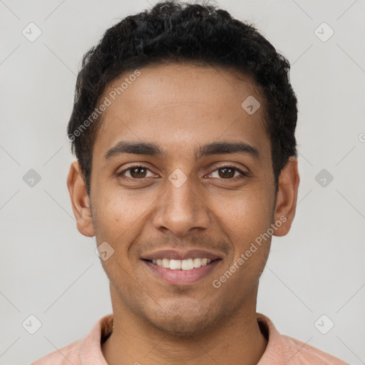 Joyful latino young-adult male with short  brown hair and brown eyes