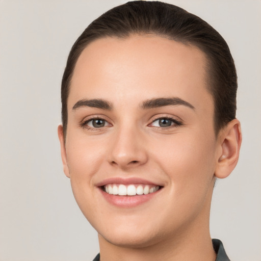 Joyful white young-adult female with short  brown hair and brown eyes