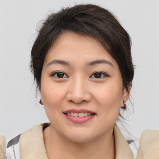 Joyful asian young-adult female with medium  brown hair and brown eyes