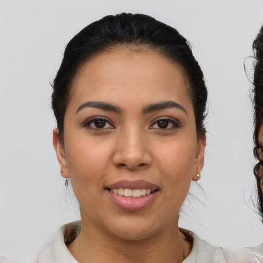 Joyful latino young-adult female with short  brown hair and brown eyes