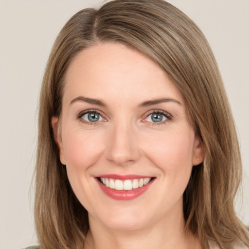 Joyful white young-adult female with long  brown hair and grey eyes