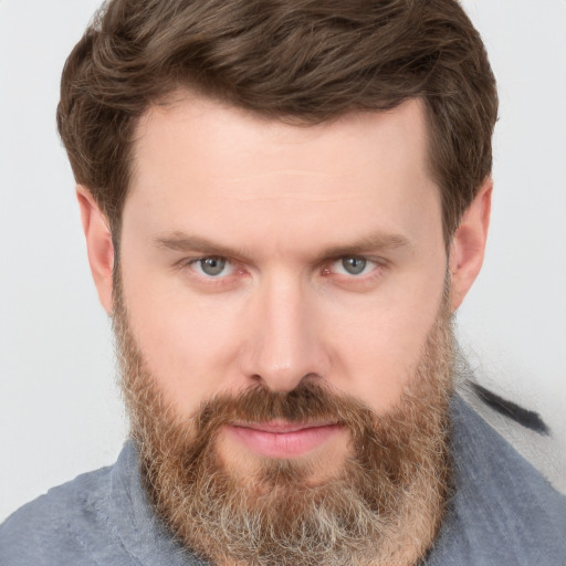 Joyful white adult male with short  brown hair and grey eyes