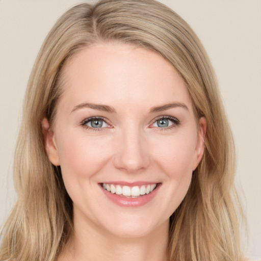 Joyful white young-adult female with long  brown hair and blue eyes