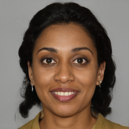 Joyful black young-adult female with medium  black hair and brown eyes