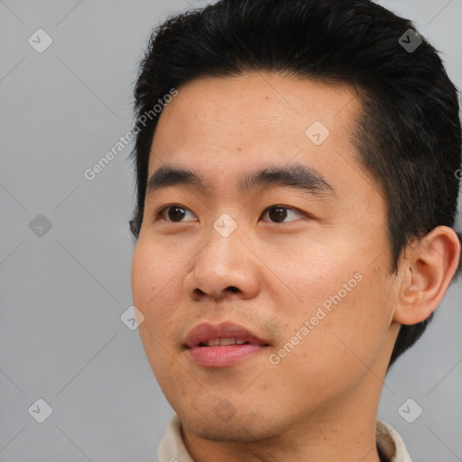 Joyful asian young-adult male with short  black hair and brown eyes