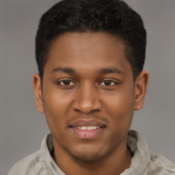 Joyful latino young-adult male with short  brown hair and brown eyes