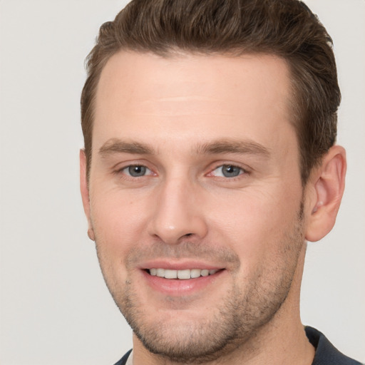 Joyful white young-adult male with short  brown hair and brown eyes