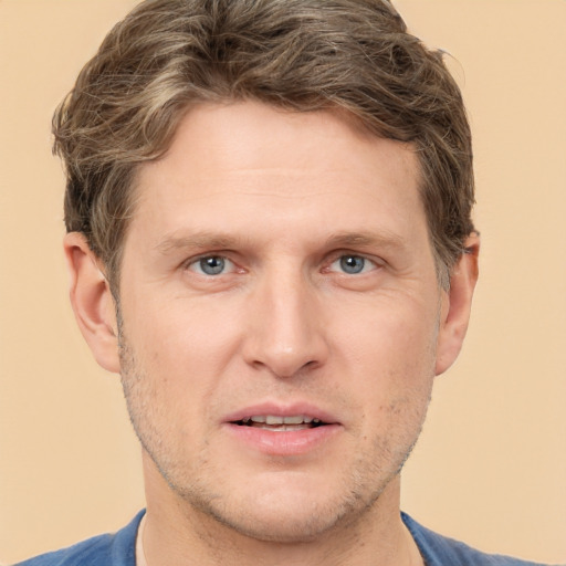 Joyful white adult male with short  brown hair and grey eyes