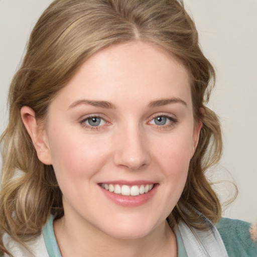 Joyful white young-adult female with medium  brown hair and blue eyes