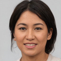 Joyful asian young-adult female with medium  brown hair and brown eyes