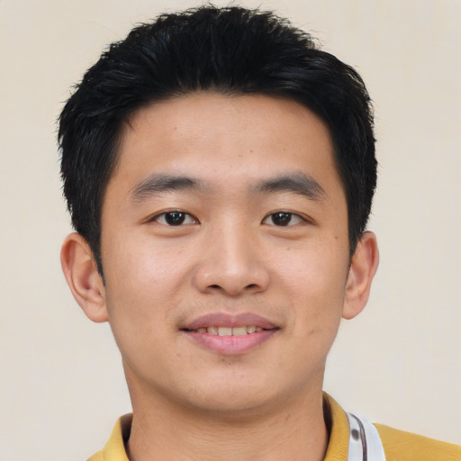 Joyful asian young-adult male with short  black hair and brown eyes
