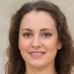 Joyful white young-adult female with long  brown hair and green eyes