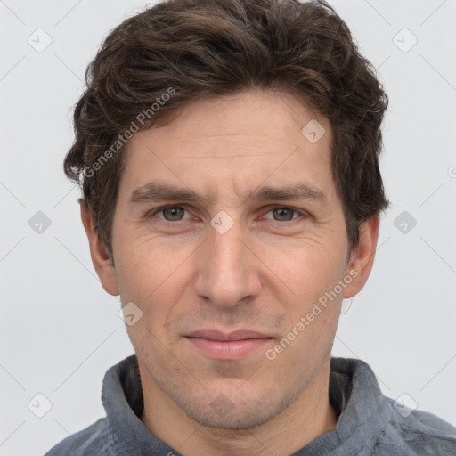 Joyful white adult male with short  brown hair and grey eyes