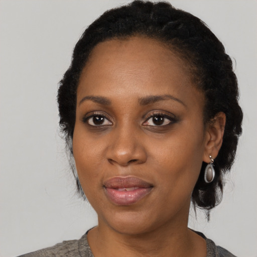 Joyful black adult female with medium  black hair and brown eyes