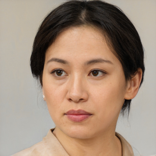 Neutral asian adult female with medium  brown hair and brown eyes