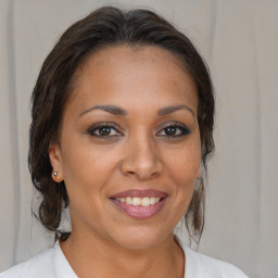 Joyful white adult female with medium  brown hair and brown eyes