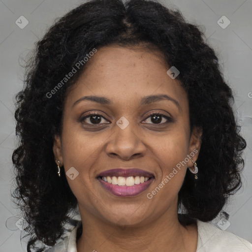 Joyful black young-adult female with long  brown hair and brown eyes