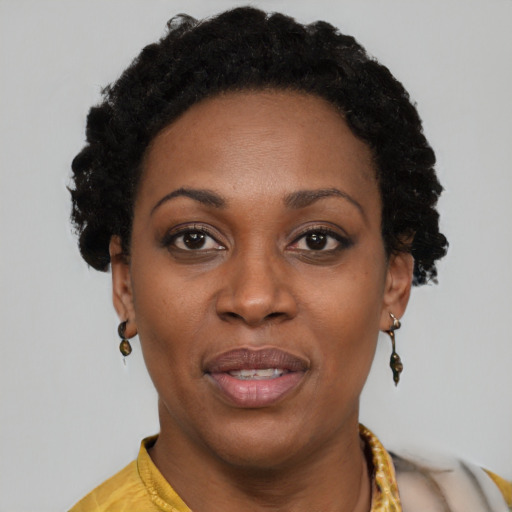 Joyful black young-adult female with short  black hair and brown eyes