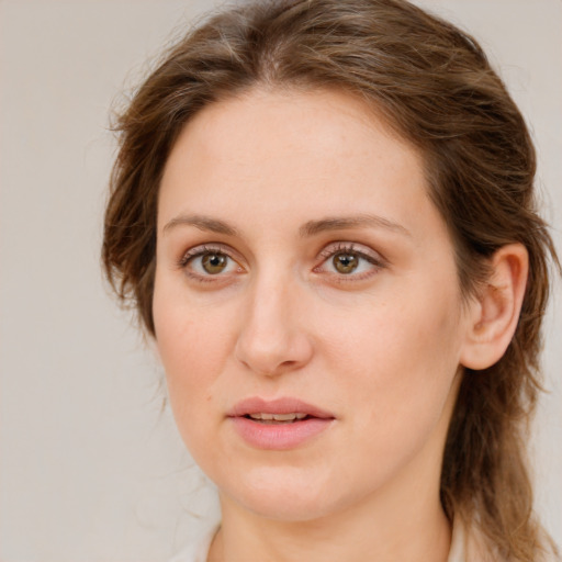 Joyful white young-adult female with medium  brown hair and green eyes