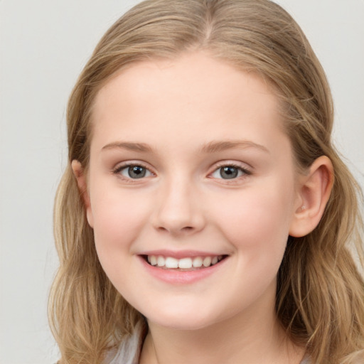 Joyful white child female with long  brown hair and grey eyes