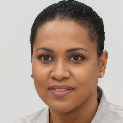Joyful black young-adult female with short  brown hair and brown eyes