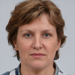 Joyful white adult female with medium  brown hair and grey eyes