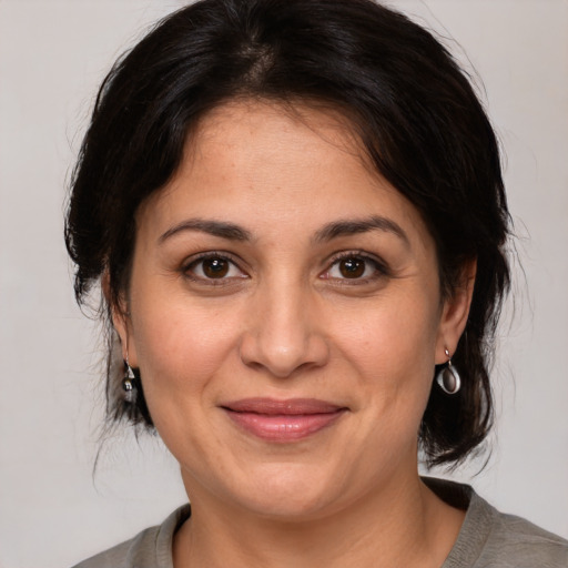 Joyful white adult female with medium  brown hair and brown eyes